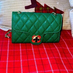 NWT rich green in color small shoulder bag with gold color hardware!